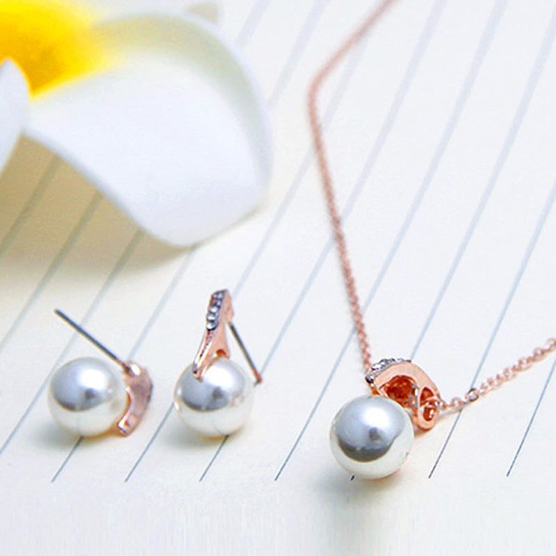 Rose Gold Pearl Pendant and Earrings Set on a velvet cushion